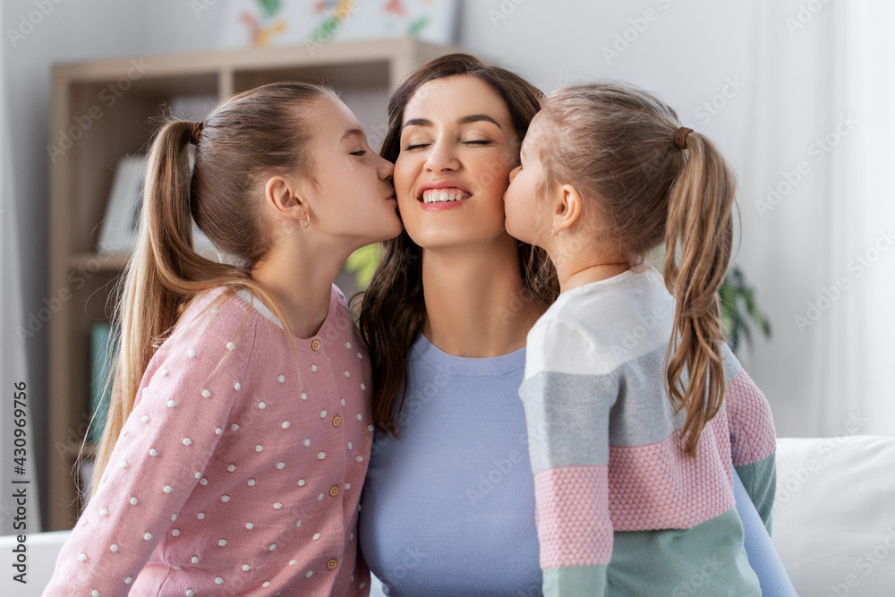people, family and love concept - two daughters kissing happy mother at home people, family and love concept - two daughters kissing happy mother at home
