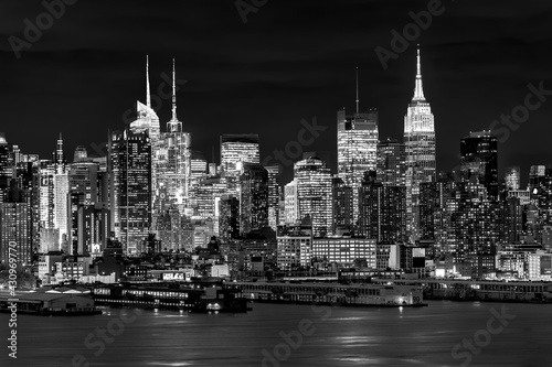 West New York City midtown Manhattan skyline view from Boulevard East Old Glory Park over Hudson River at dusk.