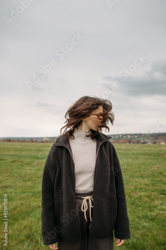 melancholic portrait of a young woman in a field
