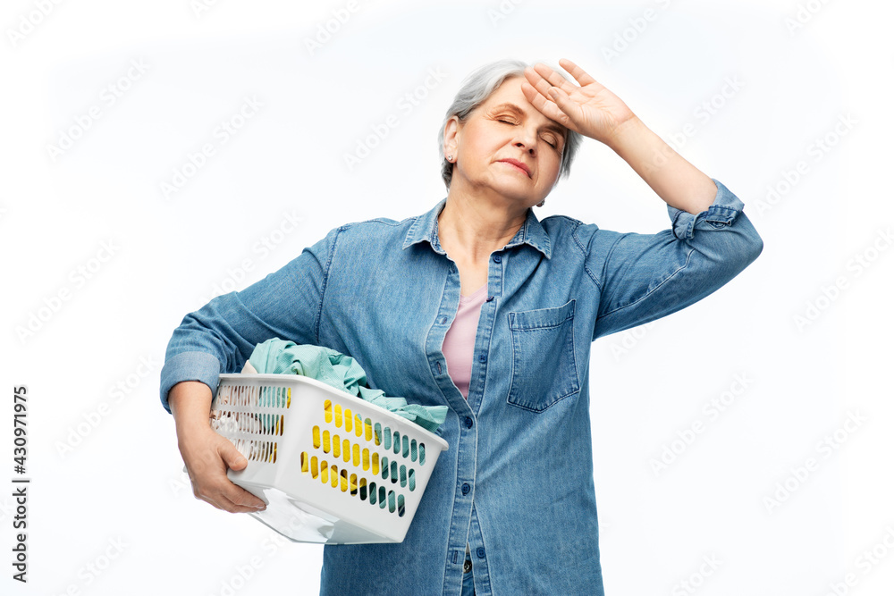 cleaning, wash and old people concept - tired senior woman in denim shirt with laundry basket over white background cleaning, wash and old people concept - tired senior woman in denim shirt with laundry basket over white background