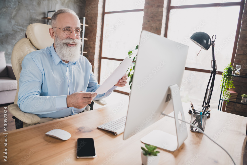 Photo of smiling happy employee dressed shirt working modern gadget holding documents indoors workplace workshop workstation Photo of smiling happy employee dressed shirt working modern gadget holding documents indoors workplace workshop workstation