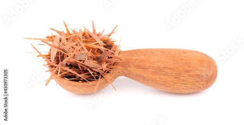 Lapacho herbal tea in wooden spoon, isolated on white background. Natural Taheeboo dry tea. Pau d'arco herb. Tabebuia heptophylla. photo