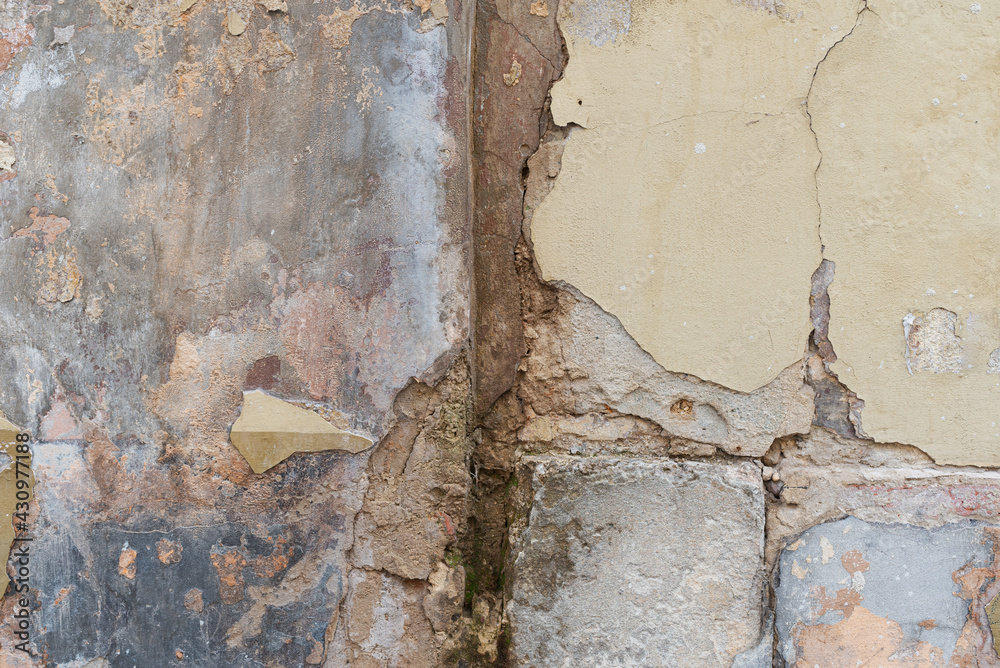 Aged plaster falls apart from an old castle wall Aged plaster falls apart from an old castle wall