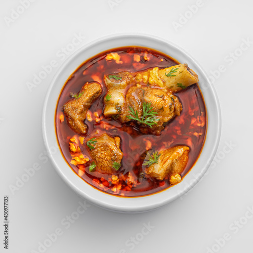 chicken or meat masala or curry in a white bowl on white background including red spicy gravy or curry 