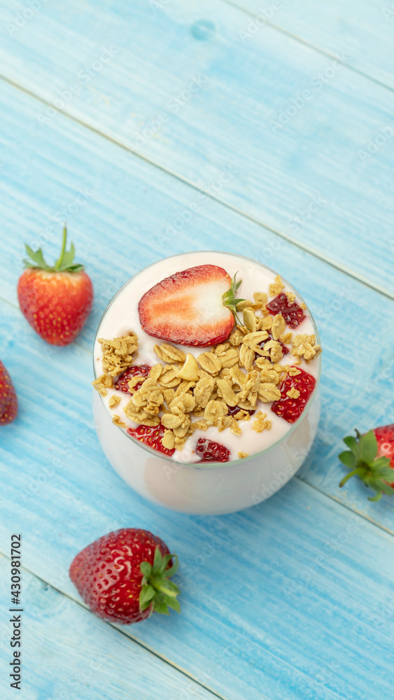 Strawberry yogurt on a blue wooden table. Strawberry yogurt on a blue wooden table.