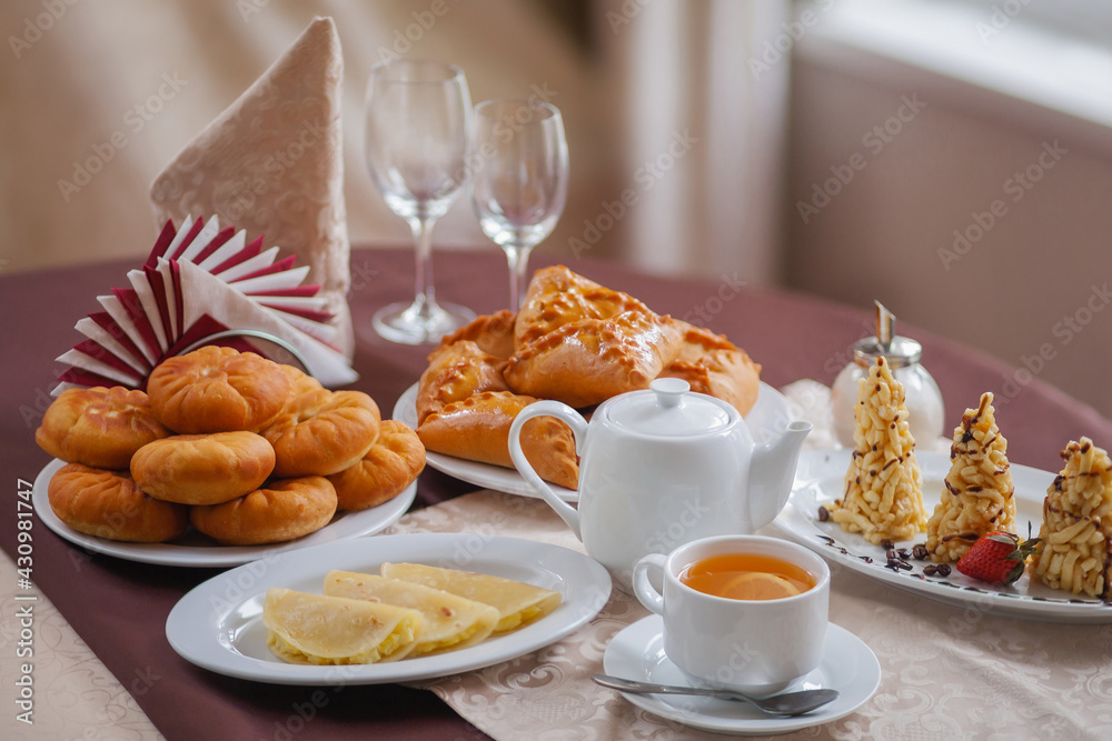 National Oriental sweets, cakes, kystybyi, tea with lemon in warm Golden tones National Oriental sweets, cakes, kystybyi, tea with lemon in warm Golden tones