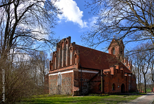 Built at the end of the 14th century in the Gothic style of red brick and stones, St. John's Catholic Church in the village of Czerniki in Masuria, Poland. The photos show a general view of the temple