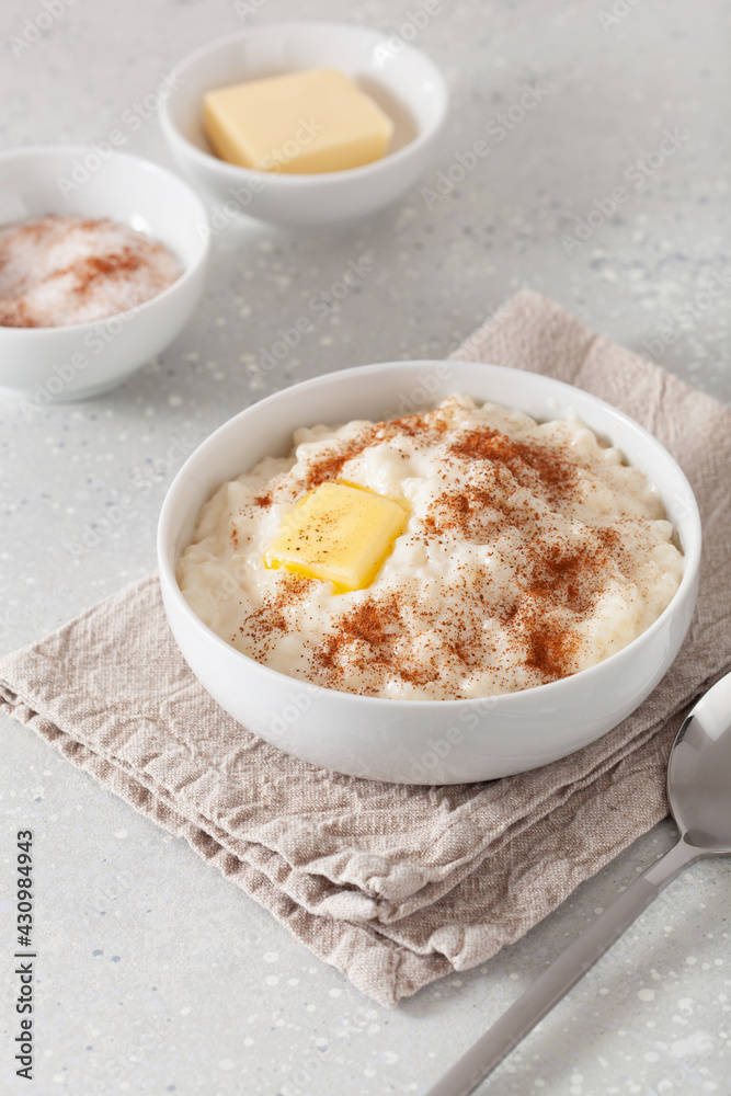 rice pudding with butter cinnamon. french riz au lait, norwegian risgrot, traditional breakfast dessert rice pudding with butter cinnamon. french riz au lait, norwegian risgrot, traditional breakfast dessert