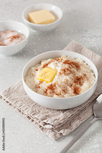 rice pudding with butter cinnamon. french riz au lait, norwegian risgrot, traditional breakfast dessert