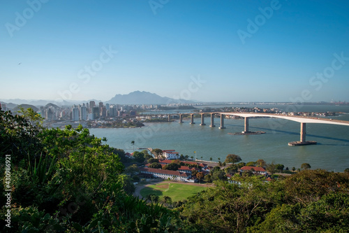 aerial view of a bridge over the sea with beach and tropical trees © tobias