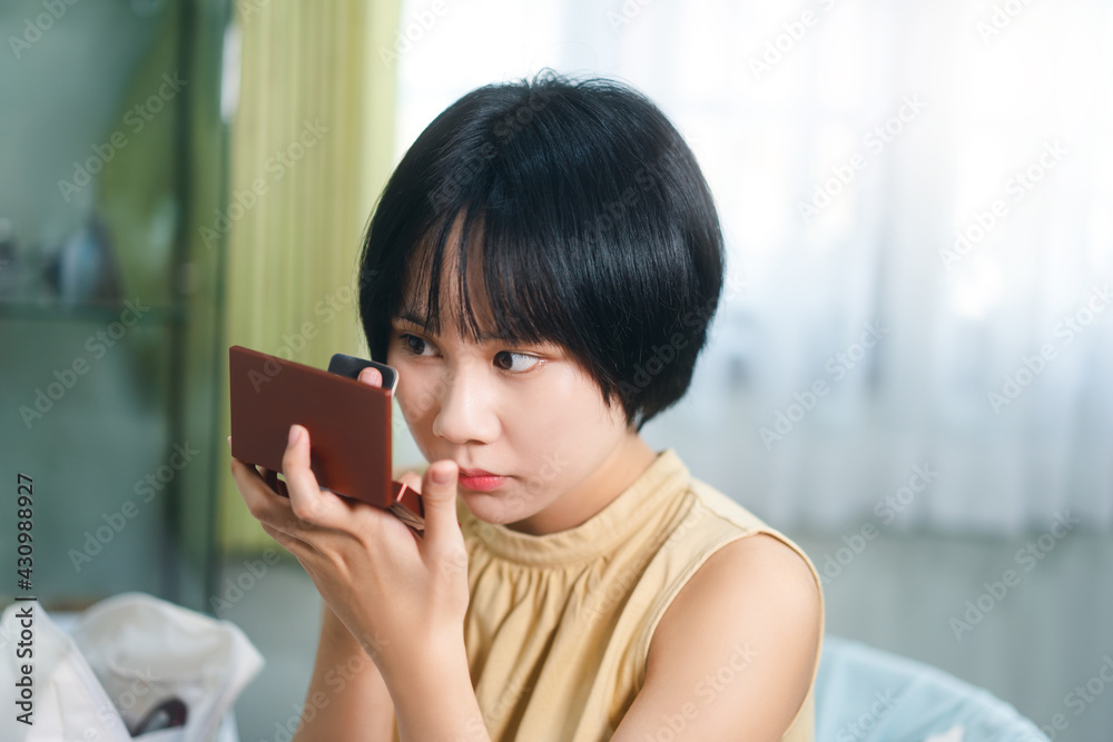 Portrait of single stills wellness young adult asian woman makeup before mirror at home. Portrait of single stills wellness young adult asian woman makeup before mirror at home.