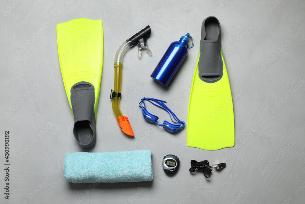 Flat lay composition with sports equipment on grey background
