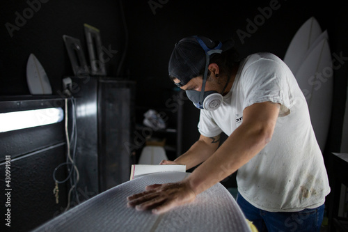 shaper modeling a new surf board photo