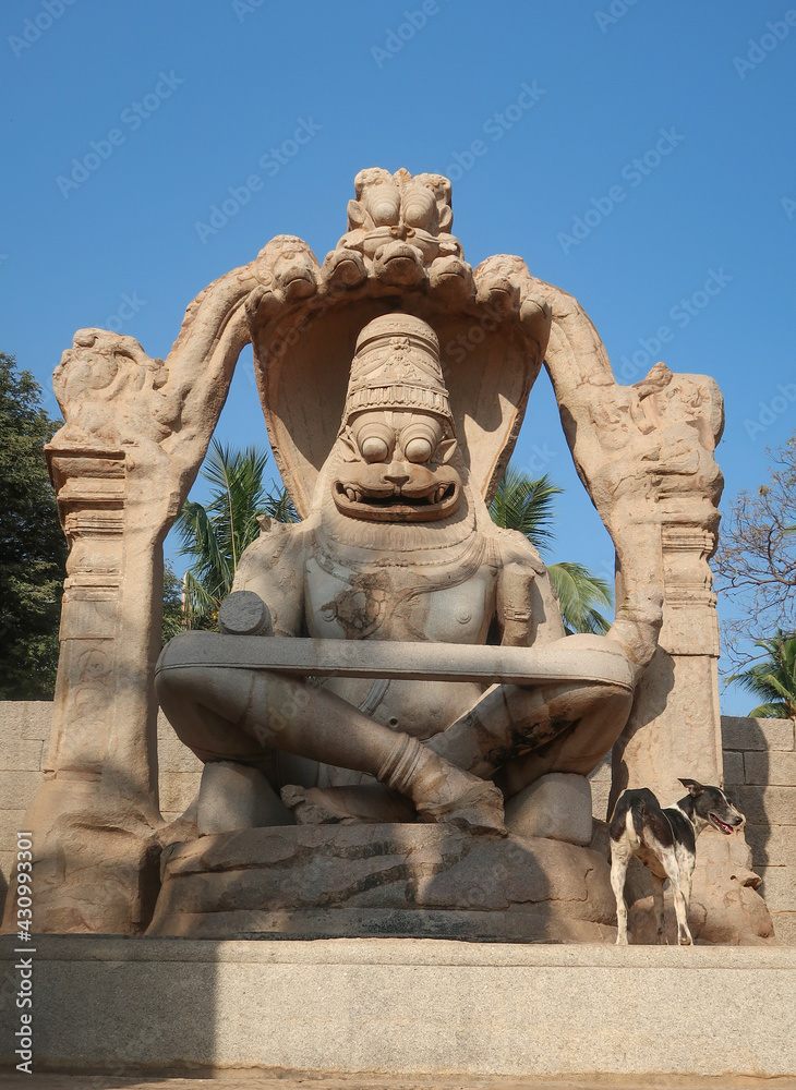 Narasimha Lakshmi temple Hampi antique stone art close-up shot from the unique angle with amazing sky image is taken at Hampi Karnataka India. This temple features the biggest effigy in Hampi. Narasimha Lakshmi temple Hampi antique stone art close-up shot from the unique angle with amazing sky image is taken at Hampi Karnataka India. This temple features the biggest effigy in Hampi.