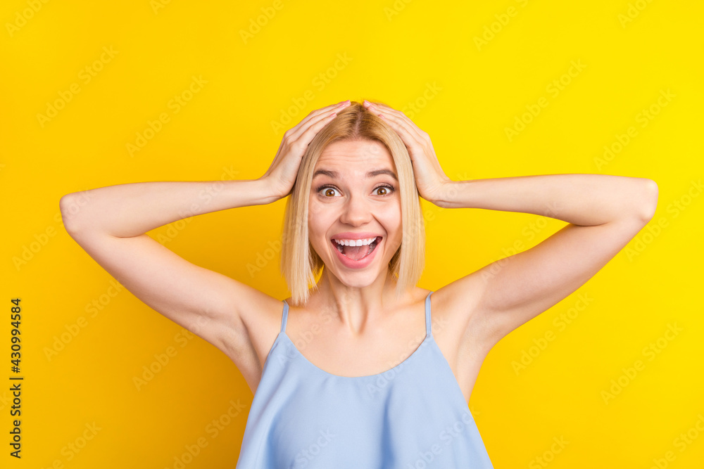 Photo of impressed cute blond short hair lady hands head wear blue top isolated on vivid yellow color background