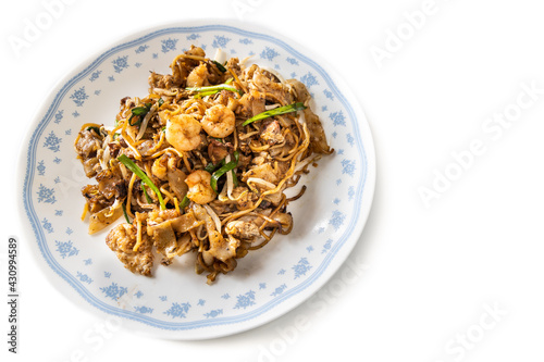 Overhead view of Penang char kuey teow is popular fried noodle with coceral, shrimp and eggs in black sauce in Malaysia