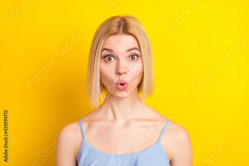 Photo of impressed blond short hair lady wear blue top isolated on vivid yellow color background