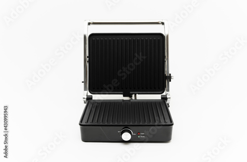 electric grill on a white background. mode wheel and electric grill control panel. household appliances.folding grill. modern electric grill