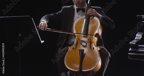 Young man playing double bass against black background 4K
