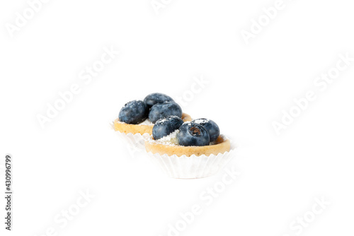 Mini tart with berries isolated, delicious tiny cakes on white background,  small blueberry cakes, sweet mini pies, gourmet dessert close-up 