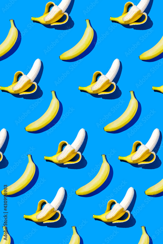 Banana pattern in hard light on blue background