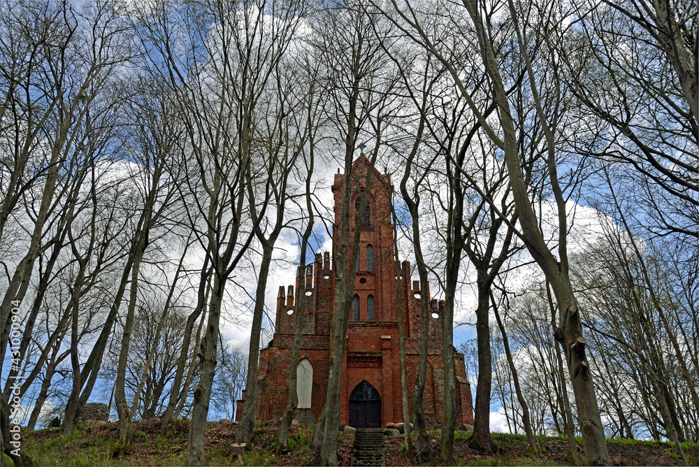 Built at the end of the 14th century in the Gothic style of red brick and stones, St. John's Catholic Church in the village of Czerniki in Masuria, Poland. The photos show a general view of the temple Built at the end of the 14th century in the Gothic style of red brick and stones, St. John's Catholic Church in the village of Czerniki in Masuria, Poland. The photos show a general view of the temple