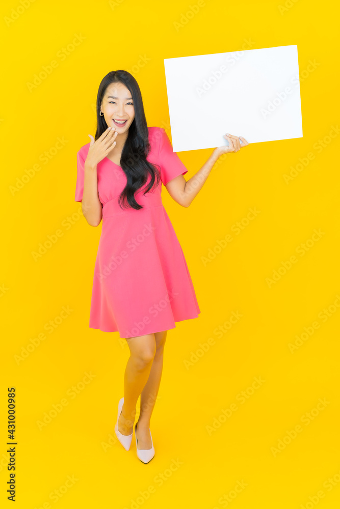 Portrait beautiful young asian woman smile with empty white billboard Portrait beautiful young asian woman smile with empty white billboard