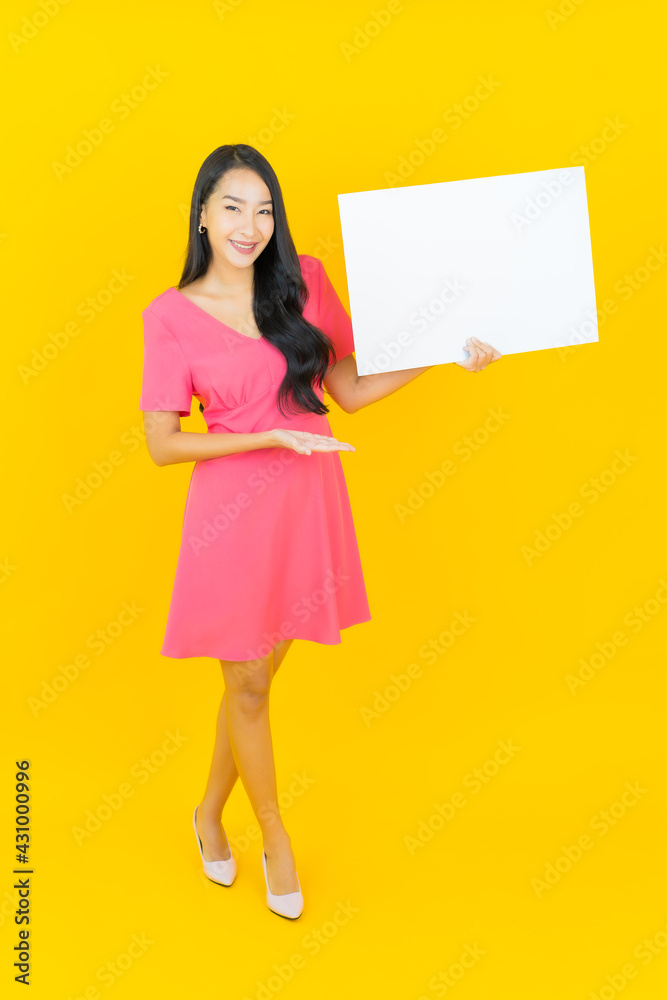 Portrait beautiful young asian woman smile with empty white billboard Portrait beautiful young asian woman smile with empty white billboard