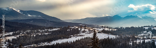 Sun rays at sunset in winter in the mountains