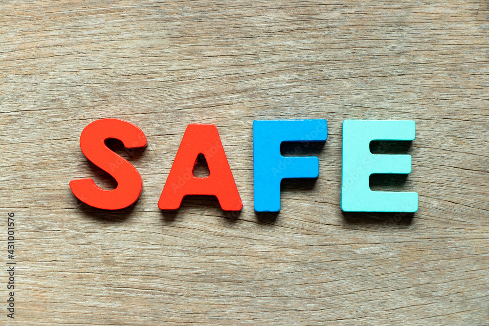 Fototapeta premium Color alphabet letter in word safe on wood background