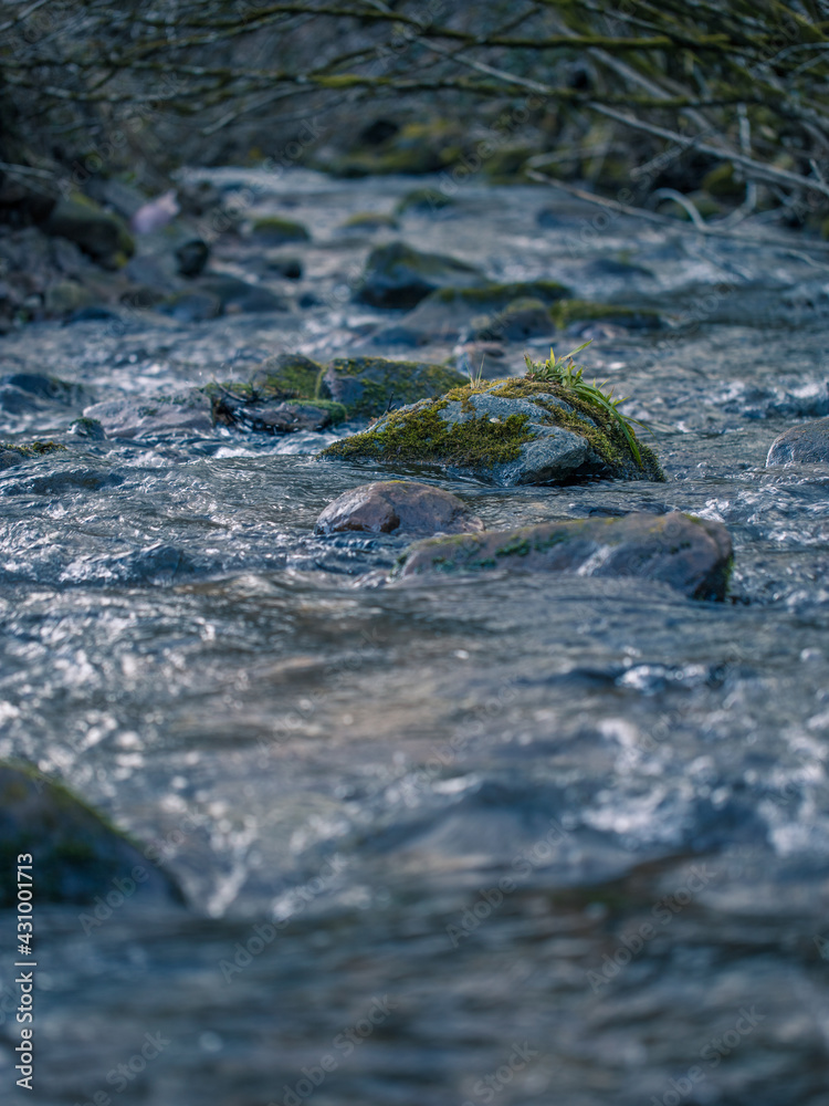 Close up of a river flowing over a stone Close up of a river flowing over a stone