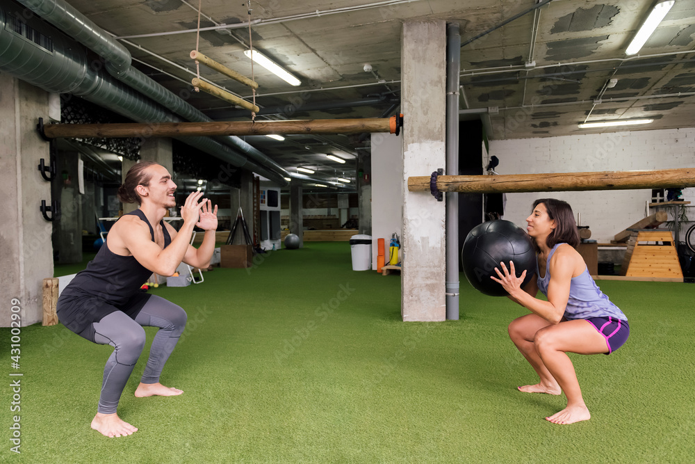 male and female athletes training together at gym male and female athletes training together at gym