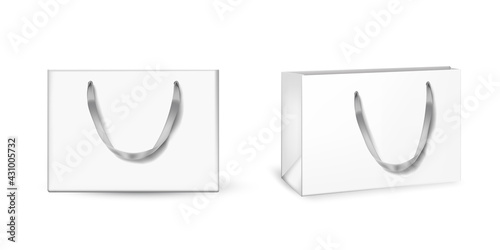 White cardboard bags set. Blank gift or shopping packages with ribbon handles vector illustration. Two realistic commercial store carton bags isolated on white background