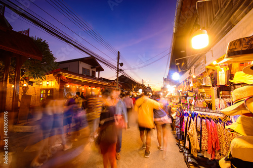 Blurred walking Loei Chiang Khan walking street and night market,Thailand people in street market at twilight with bokeh , Chinag Khan , Thailand. photo