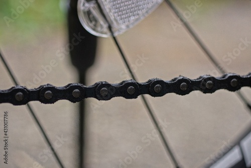 long black iron chain and gray knitting needles on a bicycle