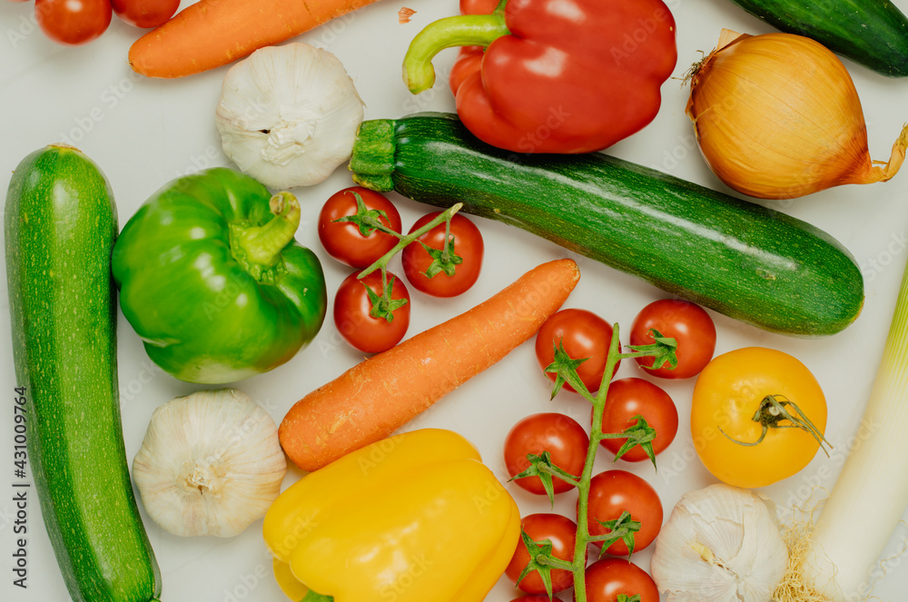 Leek, tomato, zucchini, pepper, carrot, onion and garlic on a white background. Healthy food and lifestyle. Vegetables on a white table 