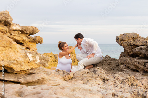 Man and woman pregnant on a beach