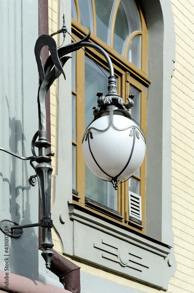 Decorative hanging street lantern mounted on the wall