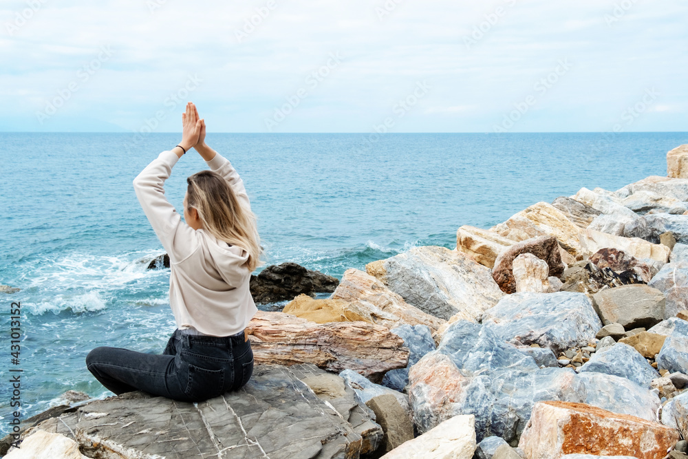 Blonde woman in lotus pose doing breathing pranayama exercise. Outdoor workout. Mindfulness zen spiritual meditation tips. Kundalini yoga. Reiki meditation. Relaxing. Unity with nature