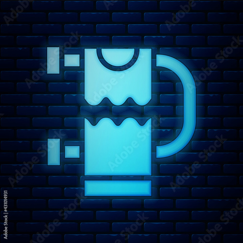 Glowing neon Heated towel rail icon isolated on brick wall background. Vector