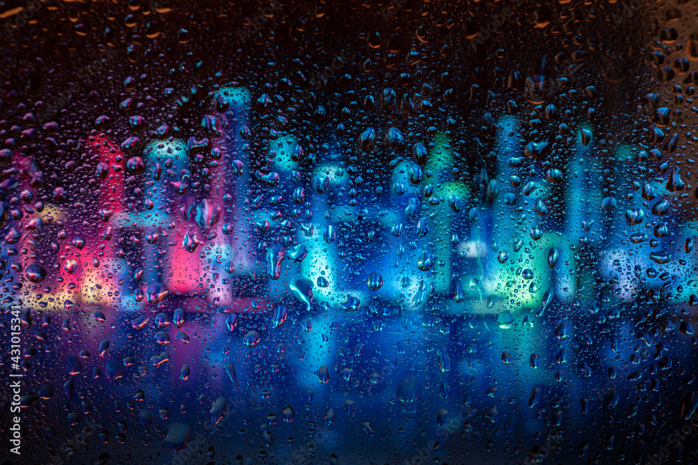 City view through a window on a rainy night,Rain drops on window with road light bokeh. Rainy days. Rain drops on window with street view ,rainy weather, rain background.