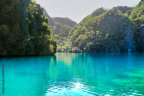 Hidden crystal clear turquoise water lake in the Philippines in summer © Pau