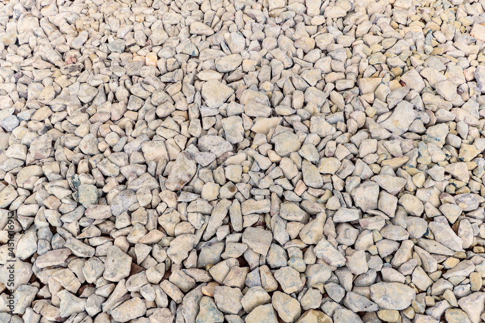 Various irregularly shaped, compacted stones as the basis for future asphalt pavement Various irregularly shaped, compacted stones as the basis for future asphalt pavement