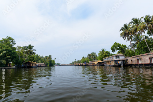 River view and traditional house boat in Kerala's Backwaters, India.