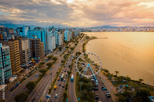 aerial image with drone on the seashore at sunset in florianópolis Santa Catarina with the ferris wheel