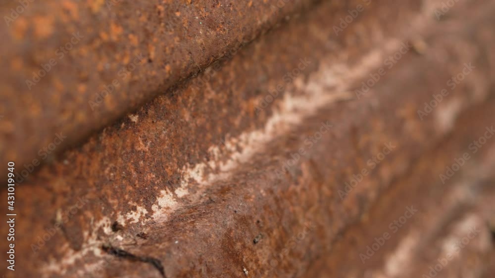 Closeup of rust on iron surface. Oxidized metal sheet. Vertical video