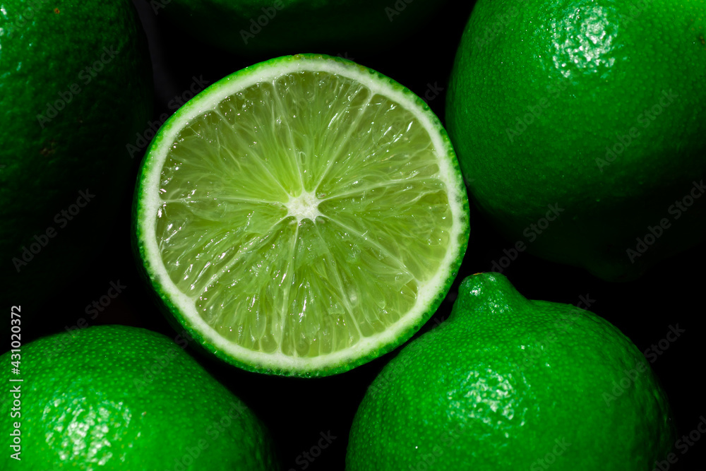 Citrus fruits of Lime slices. Healthy food green background. Realistic flat lay Citrus fruits of Lime slices. Healthy food green background. Realistic flat lay