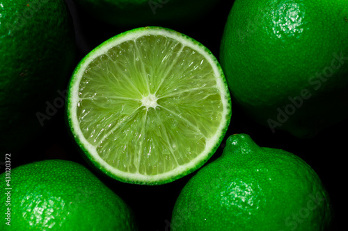Citrus fruits of Lime slices. Healthy food green background. Realistic flat lay © Taras
