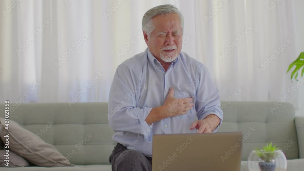 Emergency of Asian Elderly senior man sudden heart attack so pain on chest and illness with diabetes symptoms on sofa due working alone and need Urgently help at home,Elderly care concept Emergency of Asian Elderly senior man sudden heart attack so pain on chest and illness with diabetes symptoms on sofa due working alone and need Urgently help at home,Elderly care concept