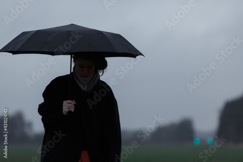 Girl with an umbrella in the field.